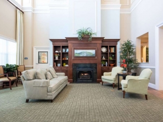 Grand Oaks of Jensen Beach Community Living Room with Fireplace